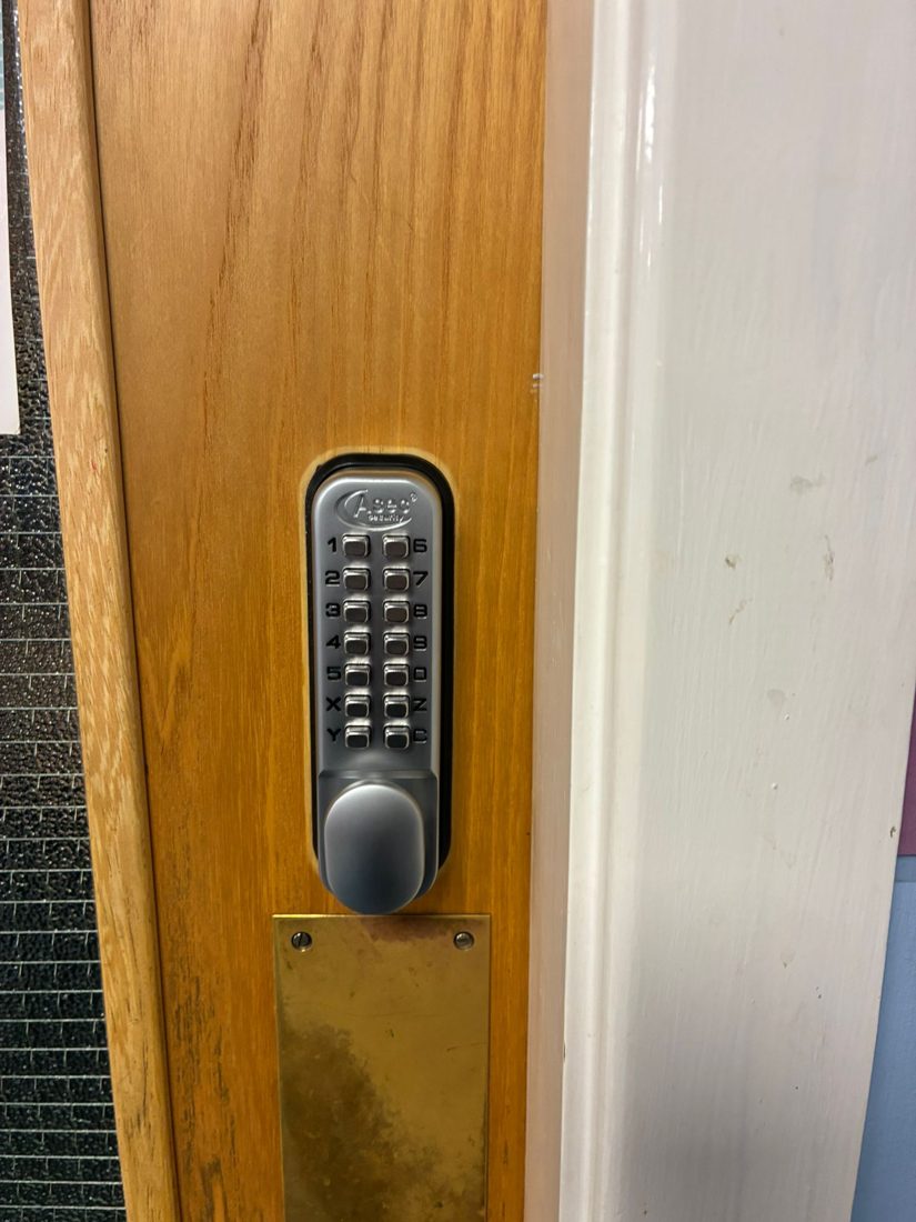 A mechanical push-button code lock fitted to a timber door