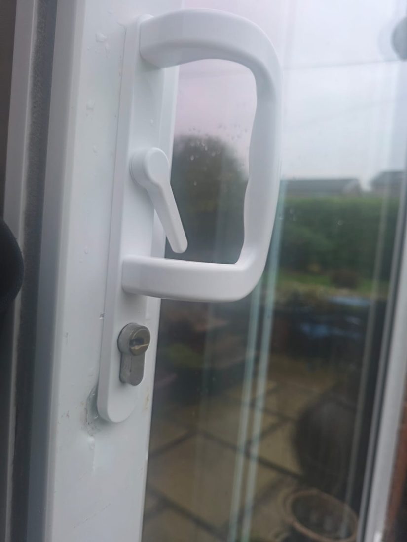 A new handle fitted to a white uPVC sliding patio door