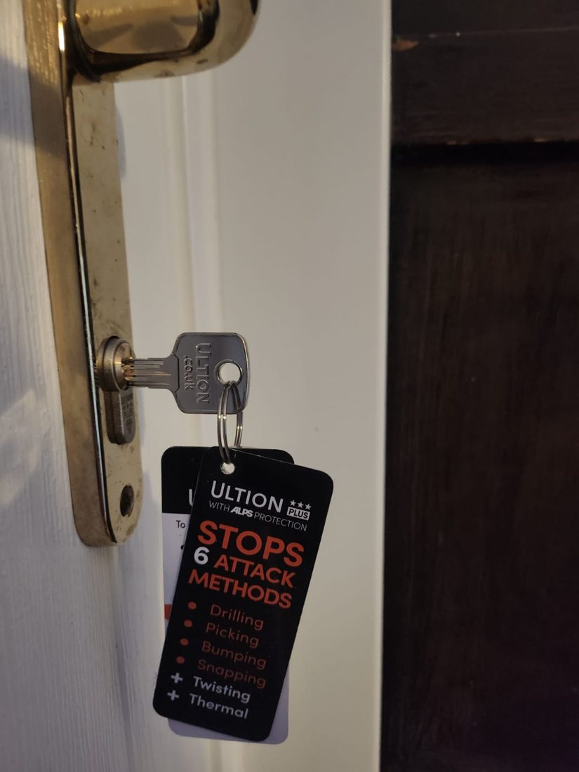 An Ultion anti-snap euro cylinder fitted, with its guarantee tag listing the attack methods it resists