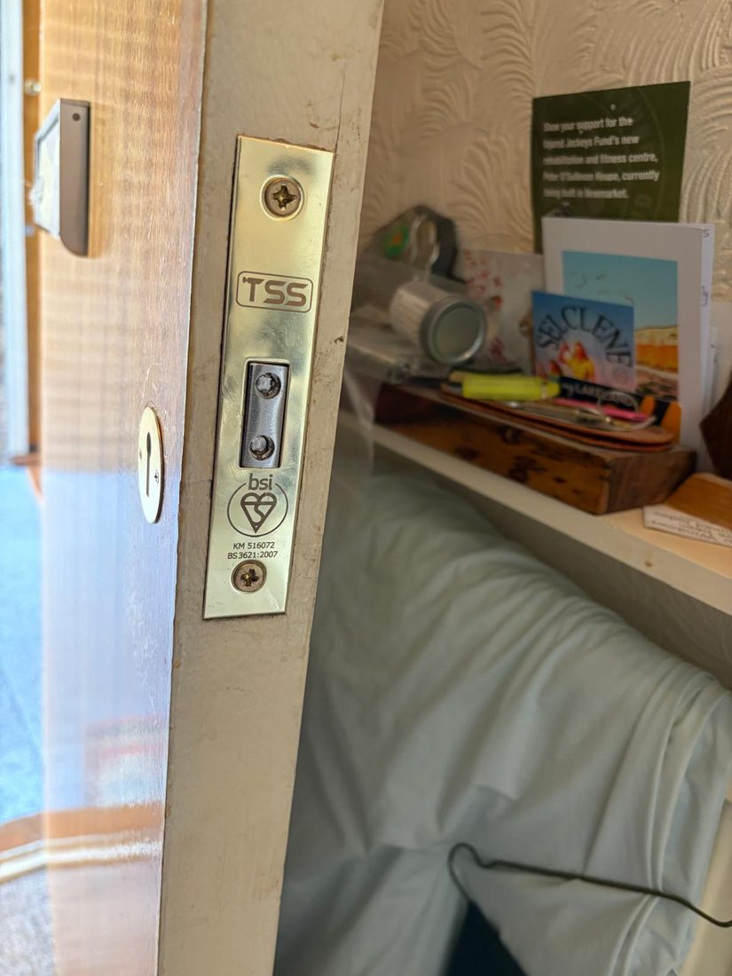 A brass mortice deadlock stamped BS 3621:2007 with the BSI kitemark, fitted to a flat door