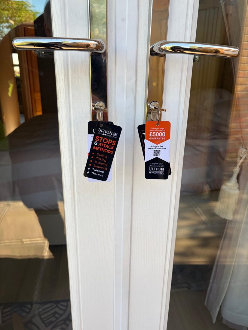 Anti-snap cylinders fitted to patio doors with Ultion guarantee tags still attached
