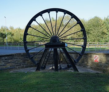 Restored colliery pit wheel displayed as a Barnsley mining memorial