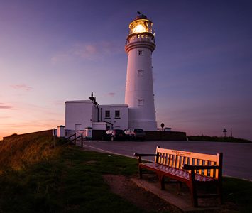 Flamborough Head Lighthouse at dusk, the white tower built in 1806 that still guides shipping around the chalk headland at Flamborough