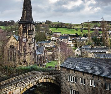 St Bartholomew's Church above the Ryburn at Ripponden, with stone houses and the surrounding hills of the Ryburn Valley