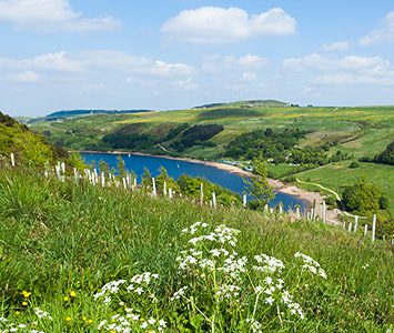 Scammonden Dam and reservoir in the hills above Huddersfield, with the M62 carried across the valley on the embankment
