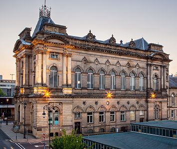 Huddersfield Town Hall on Ramsden Street, the grand Victorian building whose concert hall is home to the famous Huddersfield Choral Society, lit at dusk