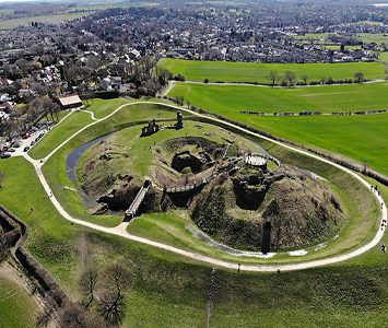 An aerial view of Sandal Castle's earthwork motte and the village of Sandal Magna spread out beyond