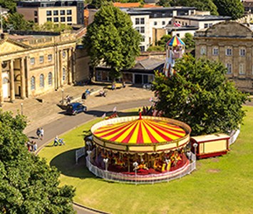 A summer's day in York, with a traditional carousel on the green